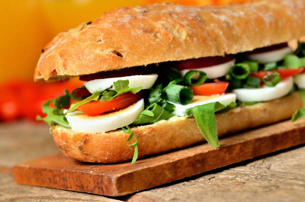 istock Baguette sandwich with egg, arugula salad, tomatoes and radish 1184846049