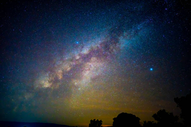 istock Beautiful milky way galaxy on dark night sky background 1184846385