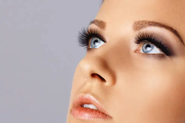 Photo of Woman face with long eyelashes and smokey eyes make-up
