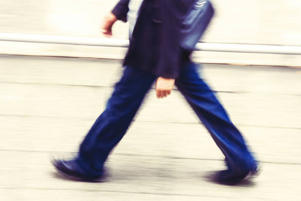 istock businessman walking in a street 1184847013