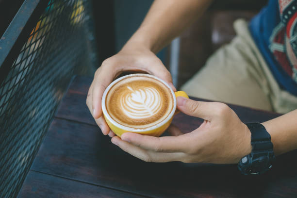 istock Close up Hands holding a cup of coffee. 1184847081