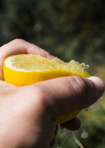 istock A lemon in the hand of a man. 1184849842
