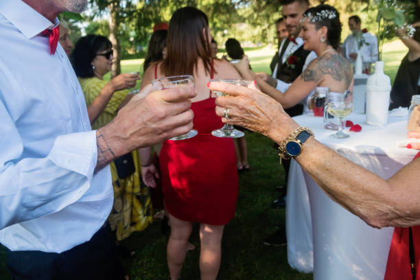 istock People toasting at wedding reception outdoors 1184849928