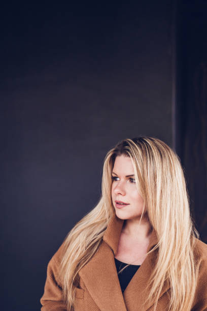istock Attractive blonde against a wall 1184850030