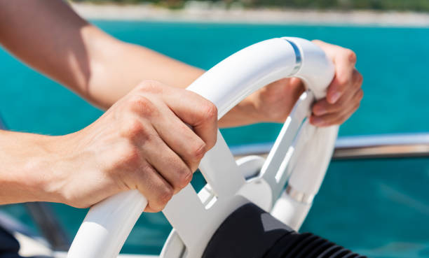 istock Hands on yacht steering wheel. 1184850419