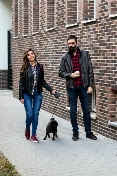 istock Couple walking with a dog 1184850512