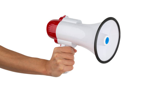istock Announcement concept. Shout It Out. Hand holds megaphone on white background. 1184851541