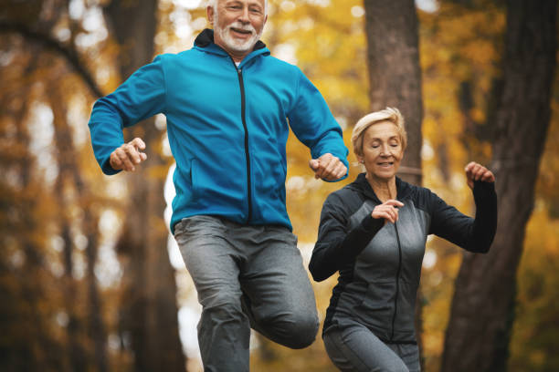 istock Senior couple jogging in a forest. 1184854006