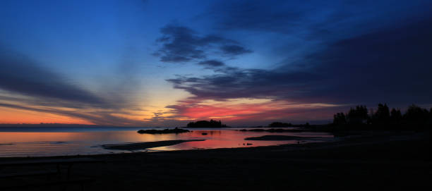 istock Bright colored morning sky over Lake Vanern, Sweden. 1184857833