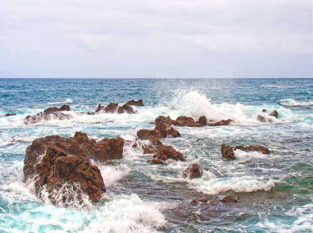 istock seascape with stormy dramatic waves breaking over coastal rocks with white surf 1184858482