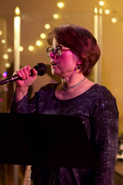 istock Senior woman singing in a live performance 1184858947