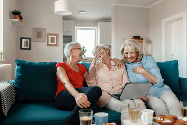 istock Group of three Senior Women at home using a Laptop 1184860539