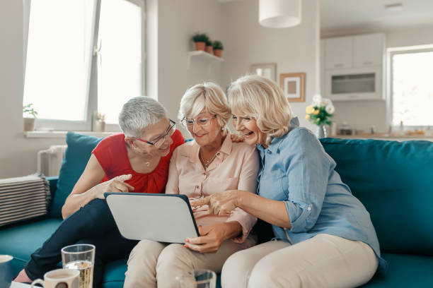 istock Group of three Senior Women at home using a Laptop 1184861933