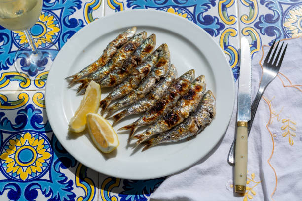 istock Espeto, Malaga style fish on stick barbecue prepared on olive tree firewoods 1184862806