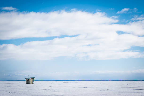 Ice fishing in Canada. Ice fishing cabin on frozen Lake Saint Pierre by the Saint Lawrence River in Quebec. ice fishing stock pictures, royalty-free photos & images