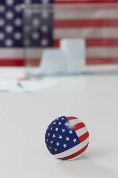 istock Ballot box and election vote buttons on table 1184865570