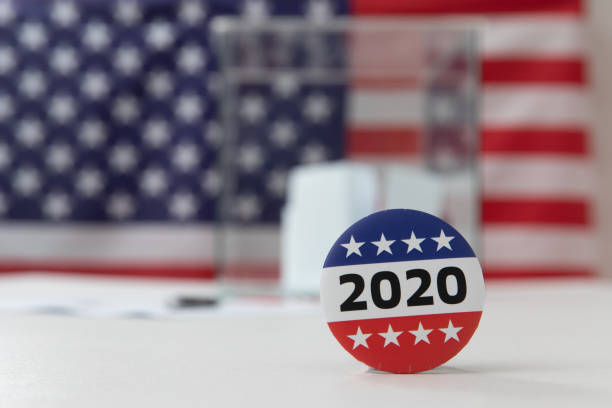 istock Ballot box and election vote buttons on table 1184865763