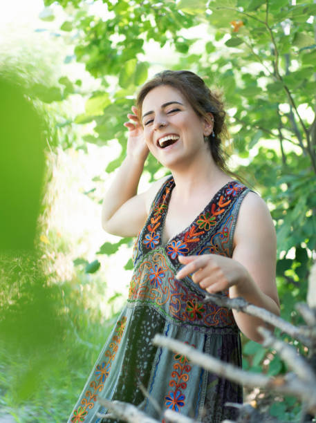 istock Young woman on floral background 1184867487