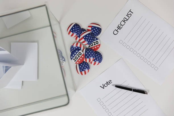 istock Ballot box and election vote buttons on table 1184867512