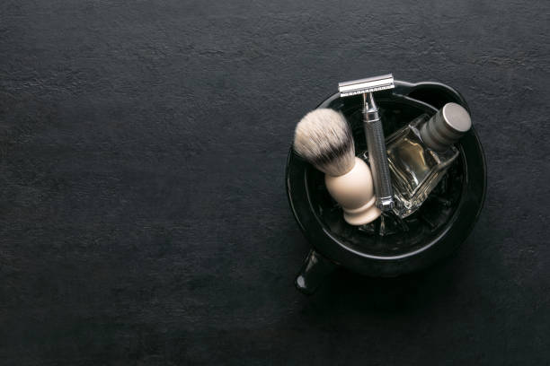 Shaving accessories set on a dark background, top down view Men shaving accessories set on a dark background, template with blank space for a text masculinity photos stock pictures, royalty-free photos & images