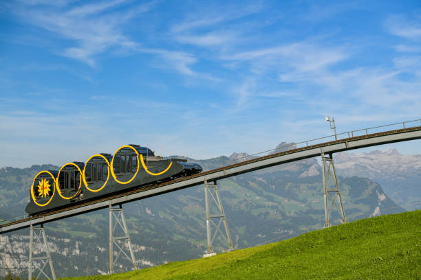 Steepest funicular of the world approaching top station in village of Stoos, Switzerland Stoos, Switzerland - September 20, 2019: Steepest funicular of the world approaching top station in village of Stoos, Switzerland during sunny day in September 2019 schwyz stock pictures, royalty-free photos & images