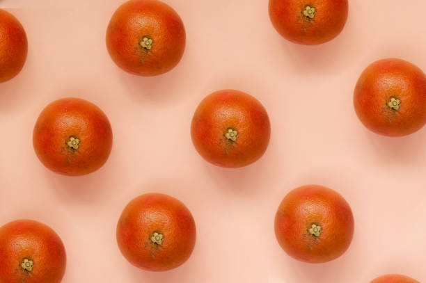 istock Fresh orange flat lay on pink background 1184869011