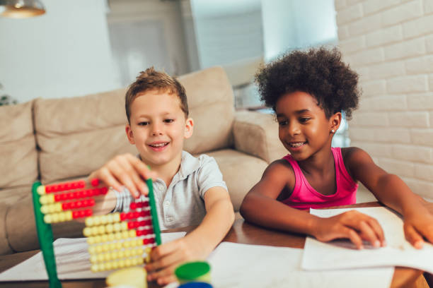 istock Multiracial children using abacus at home. 1184871565