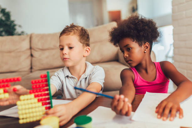 istock Multiracial children using abacus at home. 1184871652
