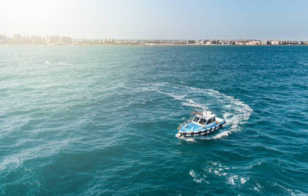 istock Small helping boat dinghy sailing in the sea. 1184874889
