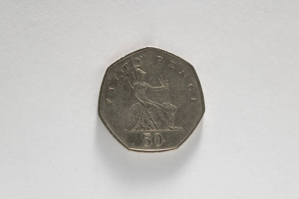 istock 50 pence corner on white background (U.K. currency) 1184877051
