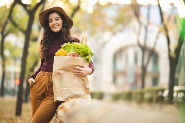 istock Woman with grocery bag 1184882729