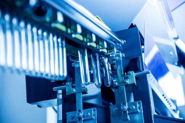 istock The plastic bottle blowing machine. PET preforms for blowing of plastic bottles. Heating process. 1184884360