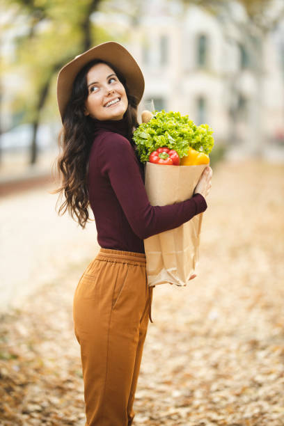 istock Woman carrying grocery 1184885042