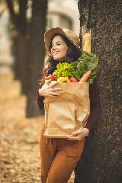 istock Woman taking a break after grocery shopping 1184885157
