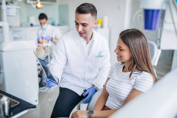 istock Dentist showing a patient her x-ray 1184886133