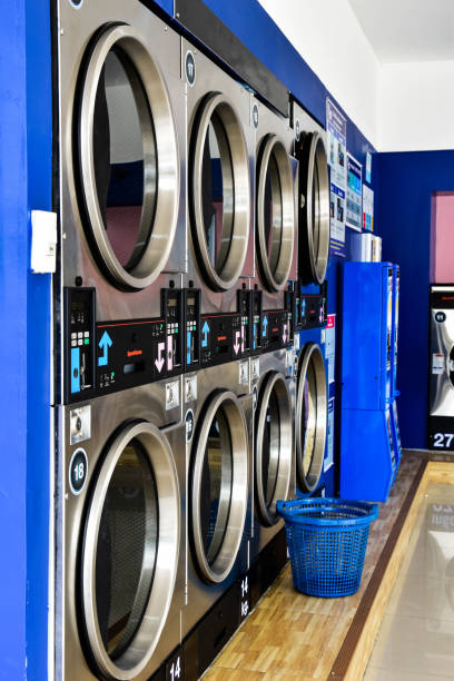istock Washing machine and dryer inside clean self service laundry room. 1184886320