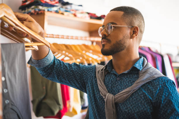 istock Clothing store owner arranging the workplace 1184887420