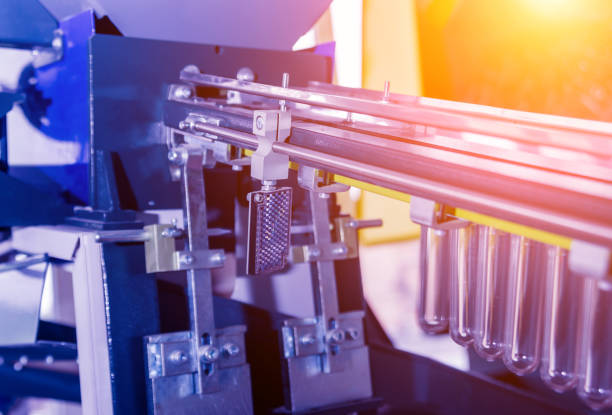 istock The plastic bottle blowing machine. PET preforms for blowing of plastic bottles. Heating process. 1184888637