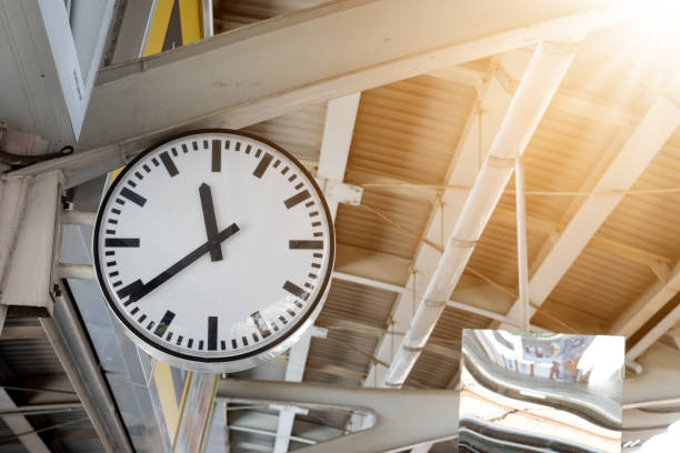 istock Clock in railway station with sunlight 1184888648