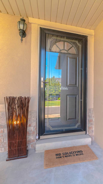 istock Vertical frame Front door and porch of modern rendered home 1184890605