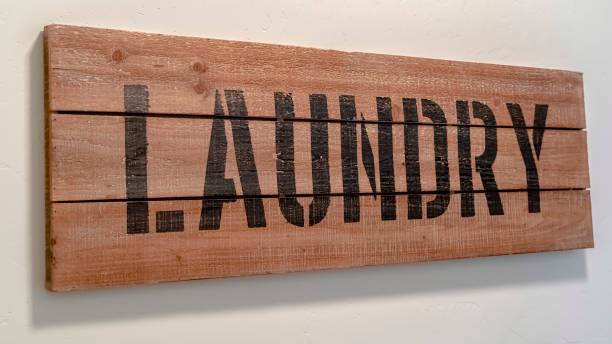 istock Panorama Rustic wooden stencilled Laundry sign on blank white wall 1184890770