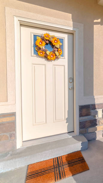 istock Vertical frame Front door of modern home with sunflower wreath 1184891695