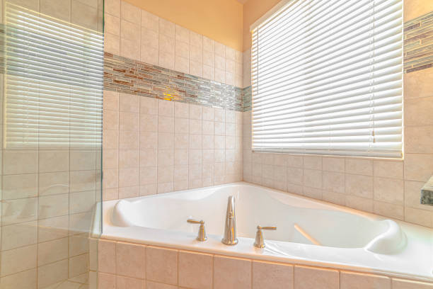 istock Tiled bathroom and spa with bright window lighting 1184891781