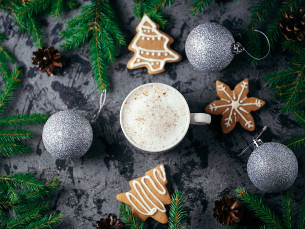 istock Christmas coffee cappuccino on the table with silver shiny balls, Christmas tree branches and ginger homemade cookies 1184891845