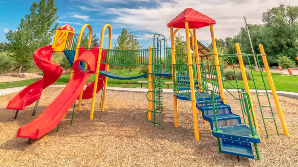 istock Panorama frame Bright colorful childrens playground under blue sky and clouds on a sunny day 1184892074
