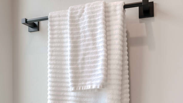 istock Panorama frame Clean white towels hanging on a towel rail 1184893048
