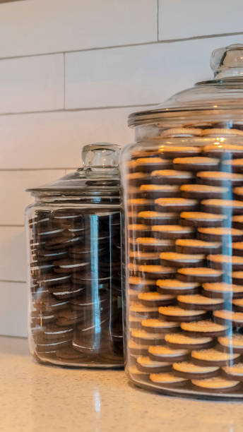 istock Vertical Large glass jars filled with cookies in kitchen 1184893068