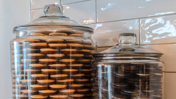istock Panorama frame Two large glass storage jars filled with cookies 1184893126
