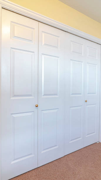 istock Vertical Closed white painted doors of a fitted wardrobe 1184893226