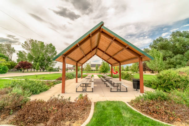 istock Beautiful scenery at a park with focus on a pavilion with tables and benches 1184893357